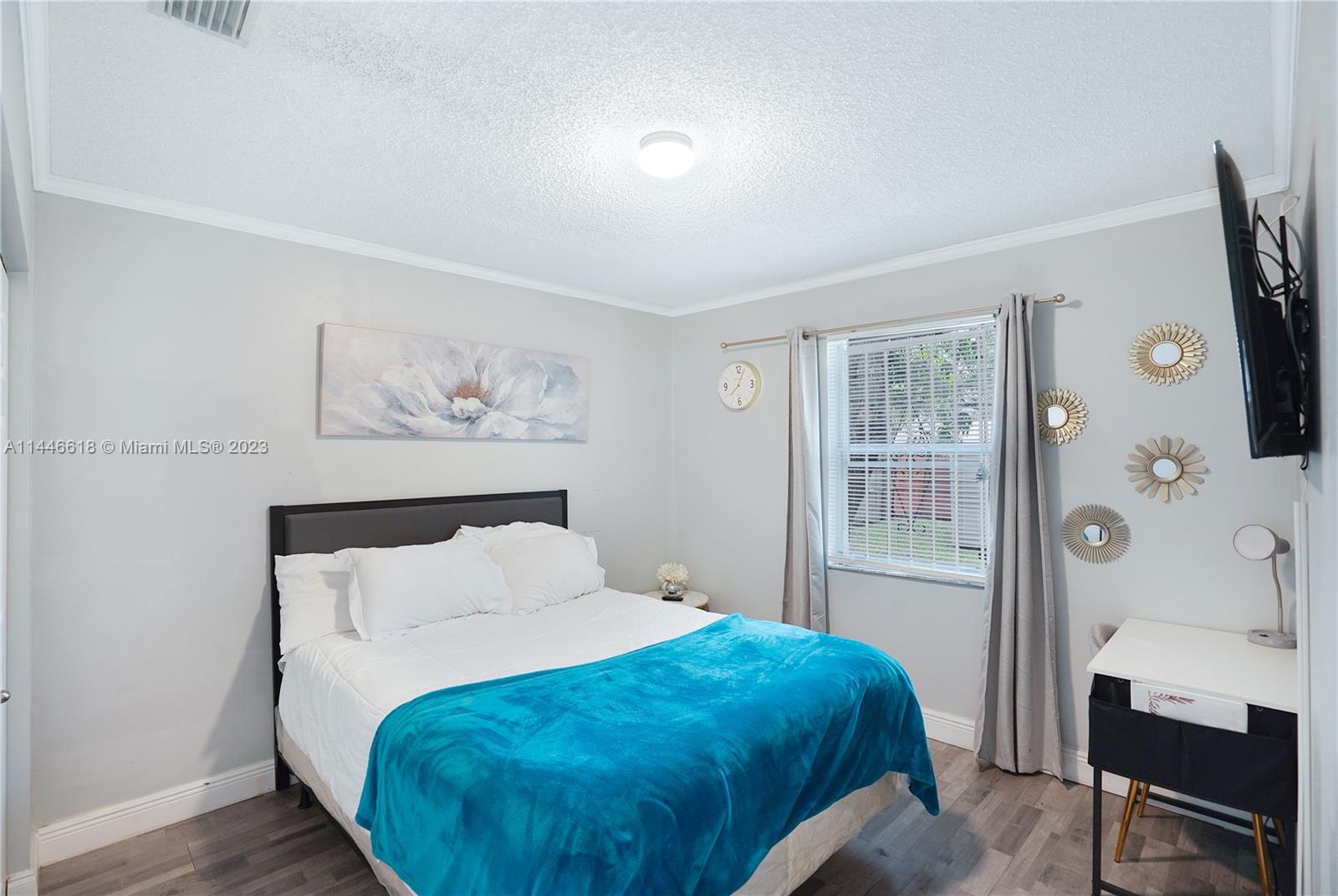 1330 Sesame Street Opa-Locka, FL 33054 - Photo 17 of 27 a bed sitting in a bedroom next to a window