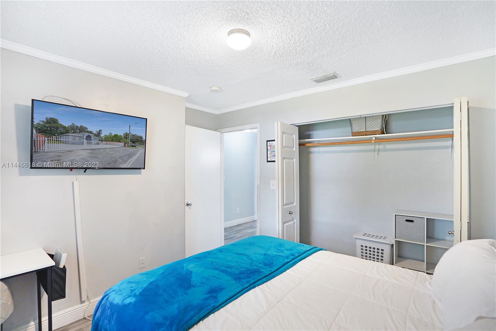 1330 Sesame Street Opa-Locka, FL 33054 - Photo 18 of 27 a bedroom with a bed and a painting on the wall