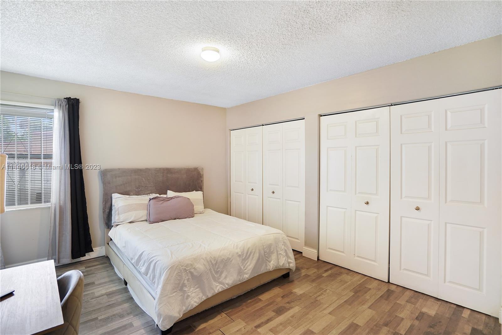 1330 Sesame Street Opa-Locka, FL 33054 - Photo 19 of 27 a bedroom with a bed and a window