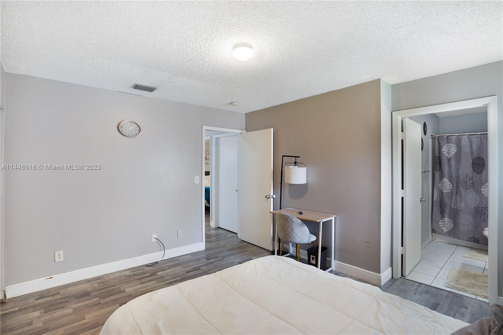 1330 Sesame Street Opa-Locka, FL 33054 - Photo 20 of 27 a bedroom with a bed and a table