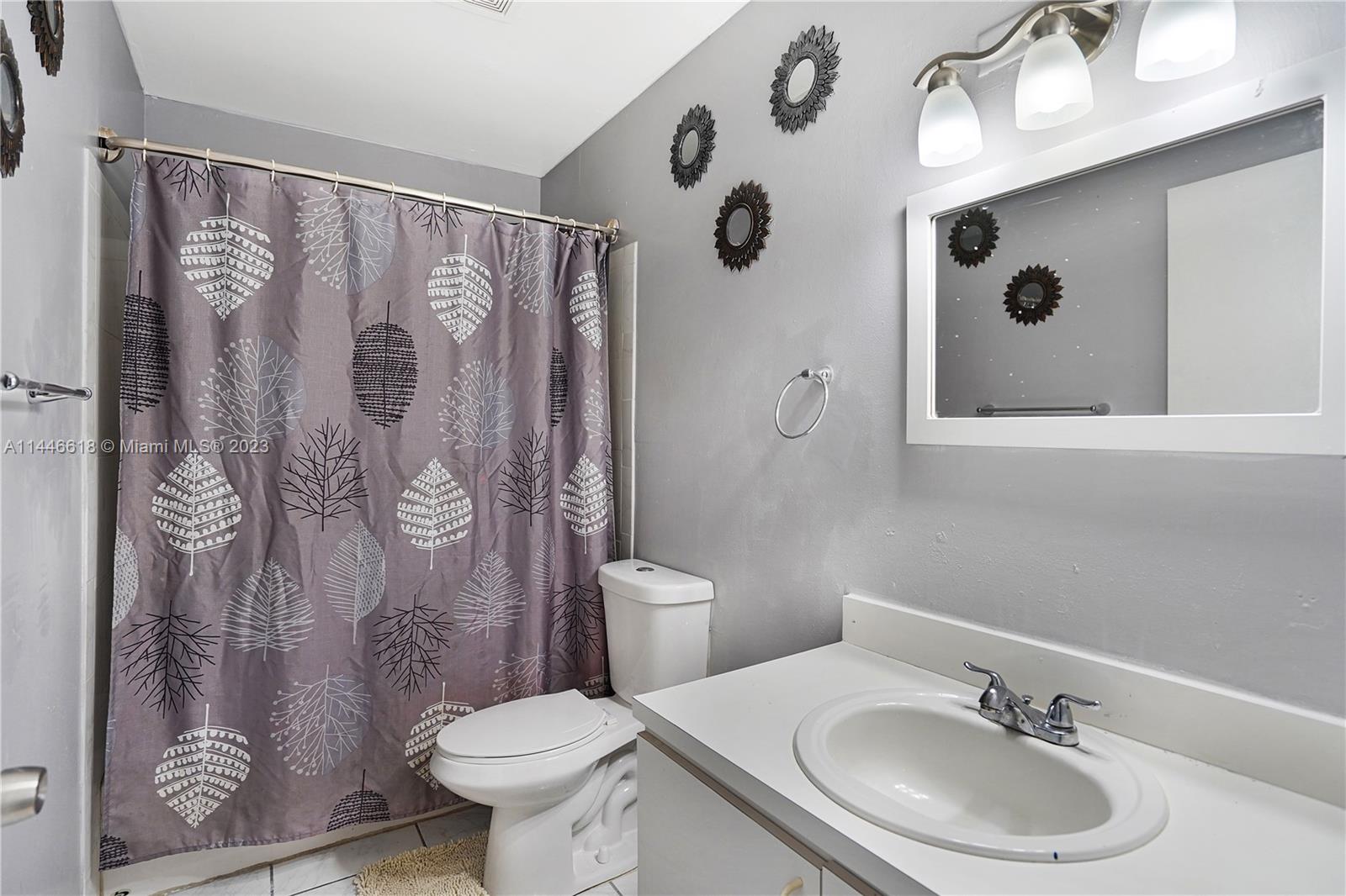 1330 Sesame Street Opa-Locka, FL 33054 - Photo 21 of 27 a bathroom with a toilet sink and mirror