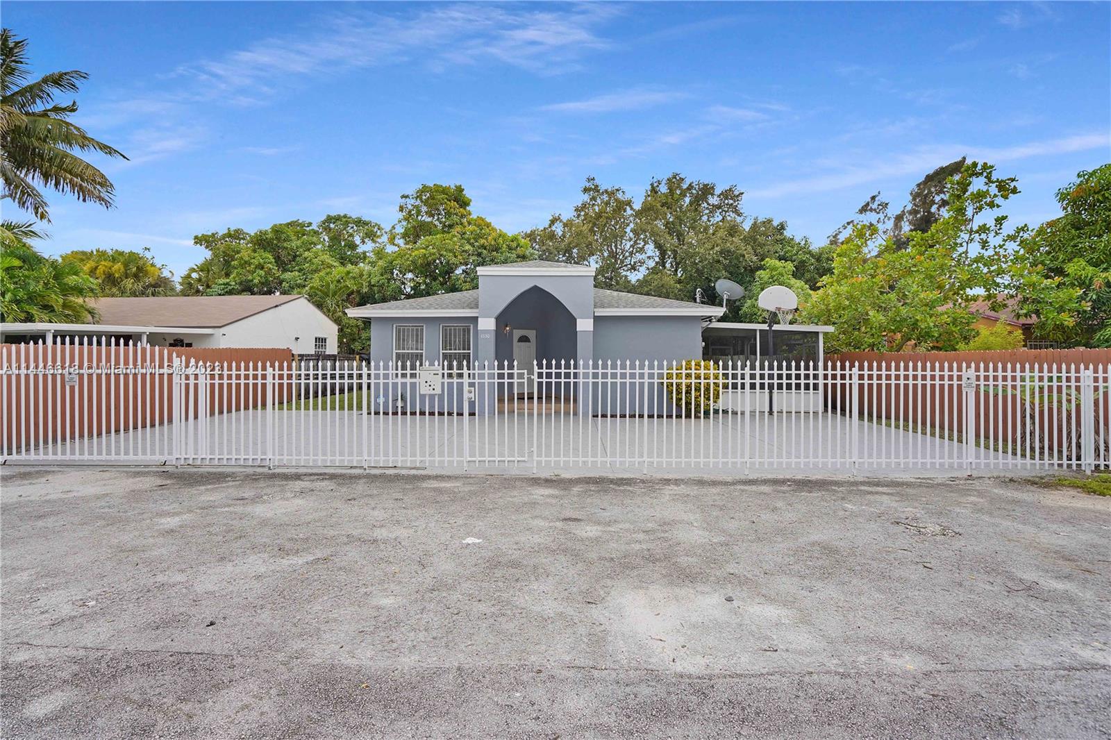 1330 Sesame Street Opa-Locka, FL 33054 - Photo 4 of 27 a view of a house with a yard and a garden