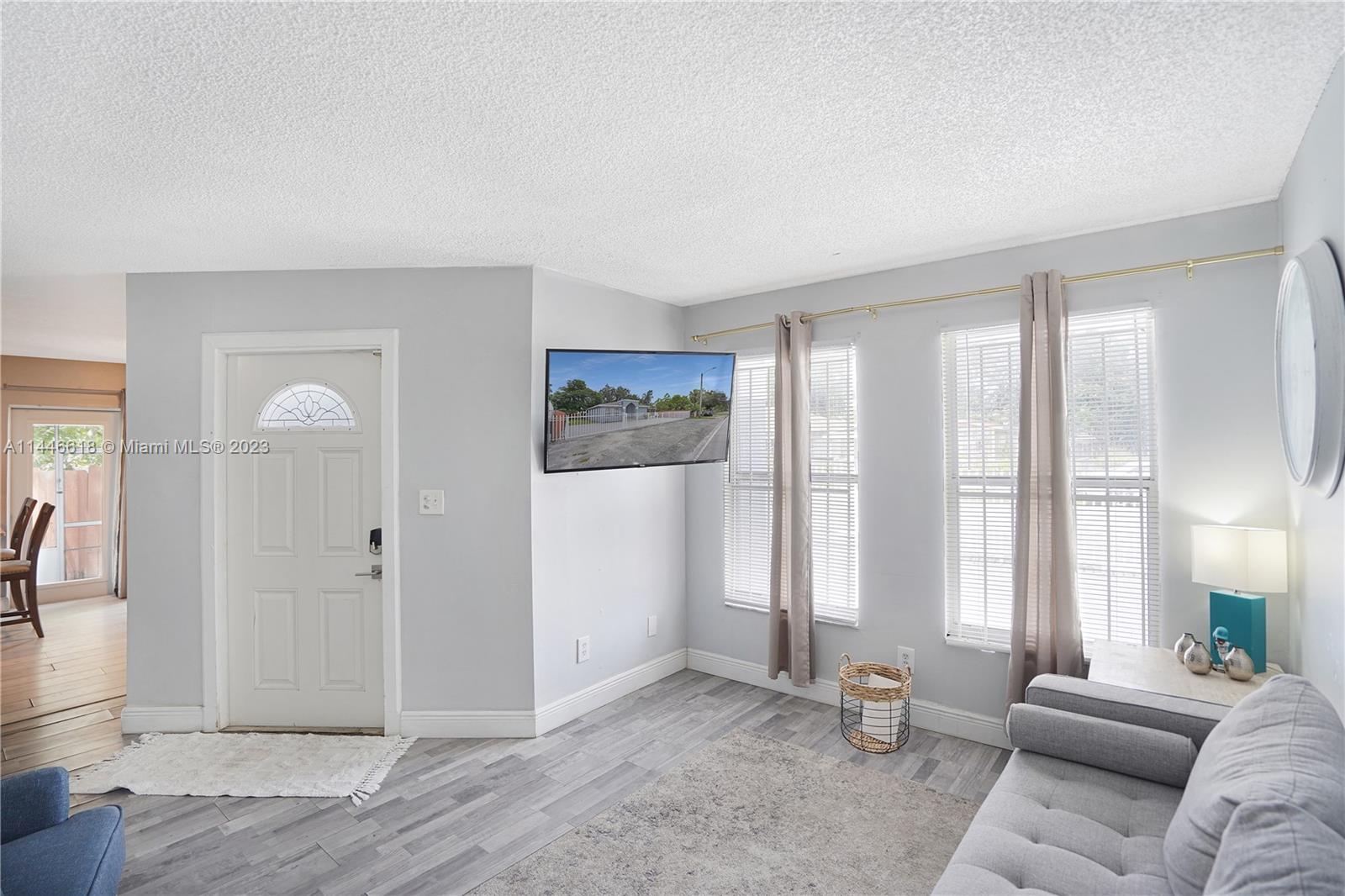 1330 Sesame Street Opa-Locka, FL 33054 - Photo 6 of 27 a living room with furniture and large windows
