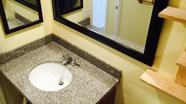 a bathroom with a shower and a sink