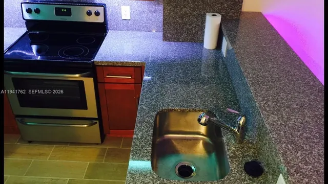 a kitchen with a refrigerator and cabinets
