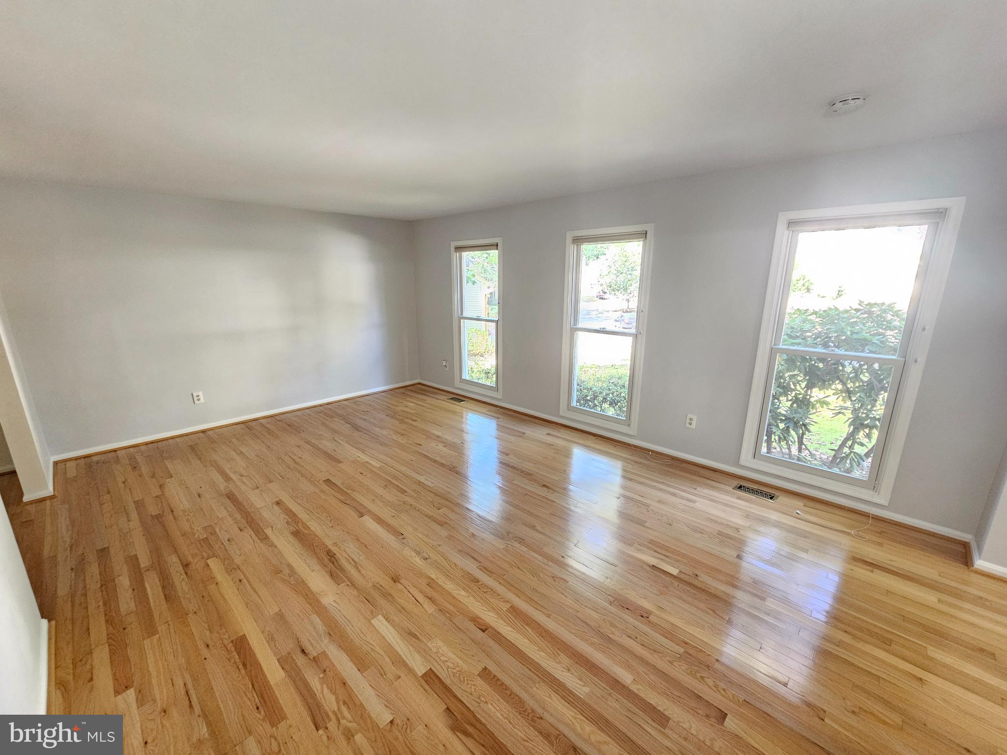11321 Classical Lane Silver Spring, MD 20901 - Photo 6 of 66 a view of an empty room with wooden floor and a window