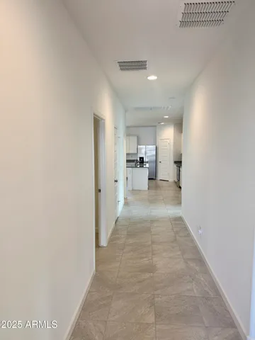 a view of a hallway with a kitchen