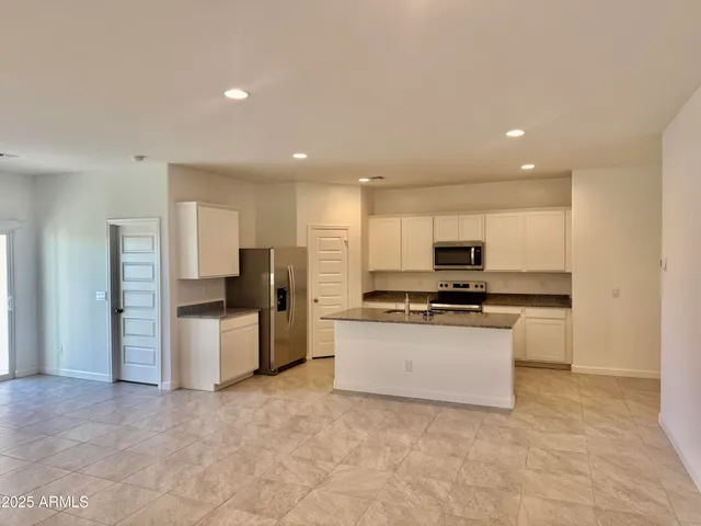 a kitchen with stainless steel appliances a refrigerator sink and stove