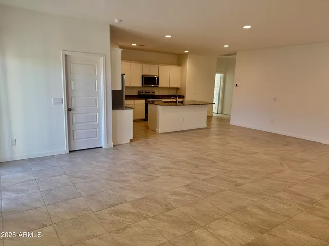 a view of kitchen view with cabinets and stainless steel appliances