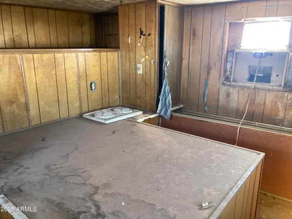 a bathroom with a granite countertop shower a sink and a window