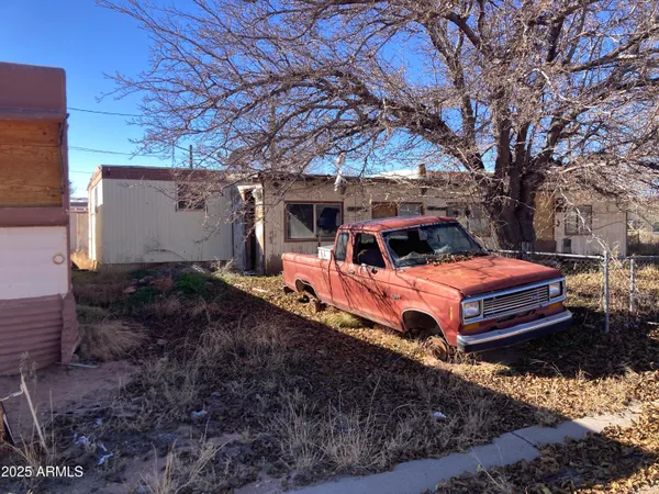 a view of a backyard with a house and a yard