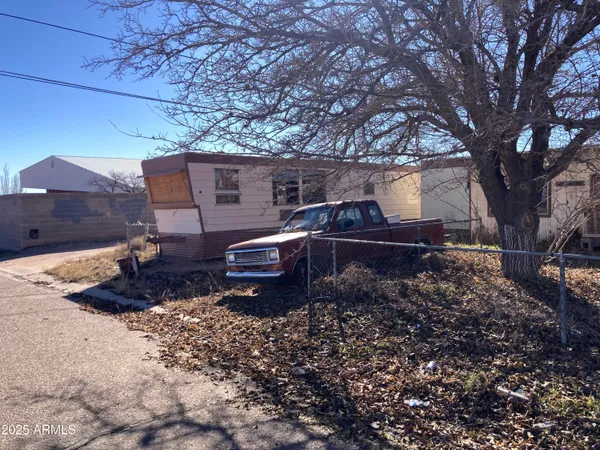 a wooden bench sitting in front of a house