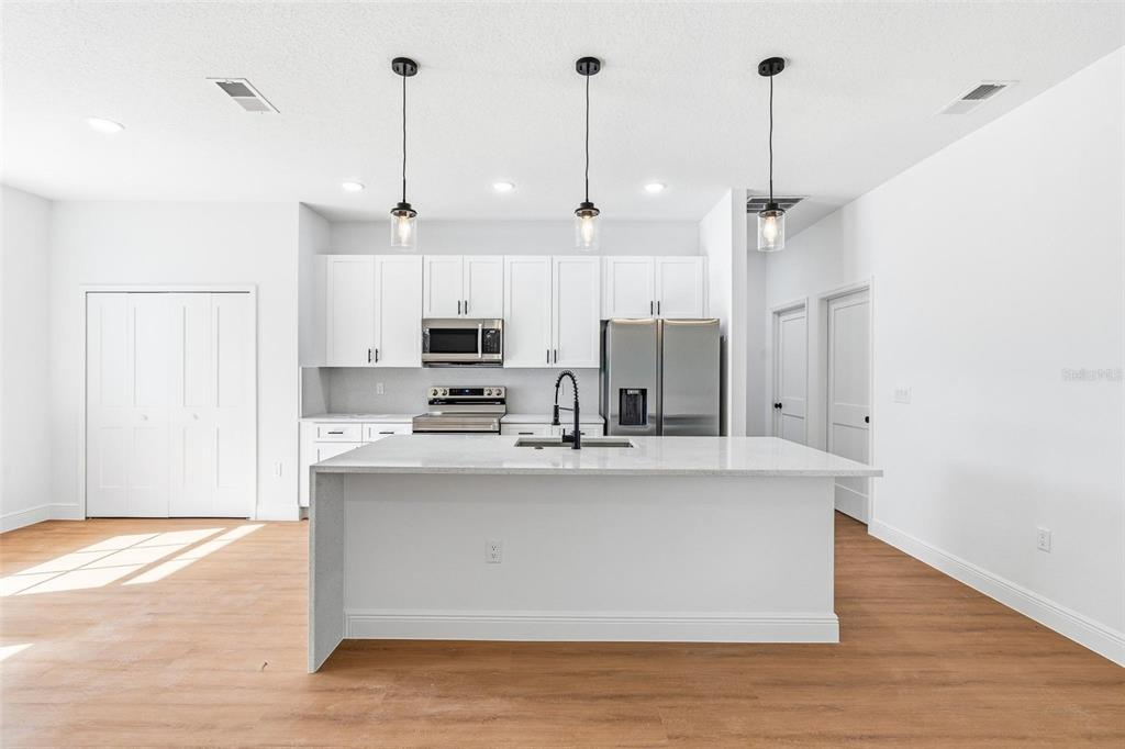 5227 Southwest 165th St Road Ocala, FL 34473 - Photo 11 of 37 a view of kitchen with stainless steel appliances granite countertop a sink a refrigerator and a stove