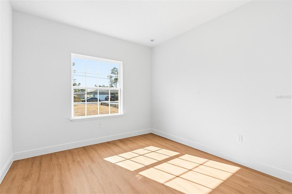 5227 Southwest 165th St Road Ocala, FL 34473 - Photo 13 of 37 an empty room with a window