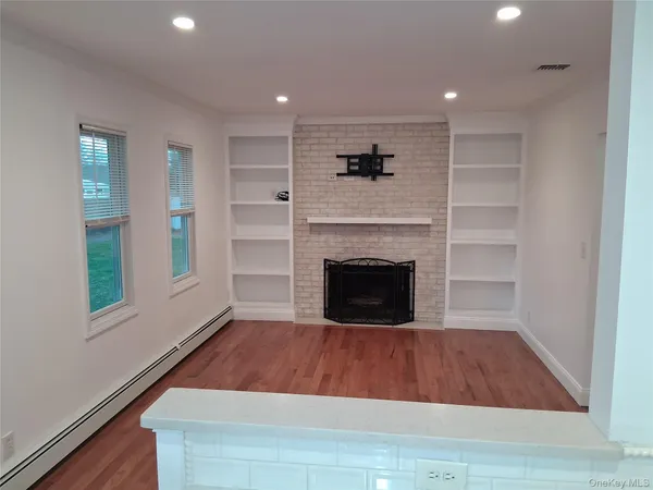 a room with a fireplace and a rug