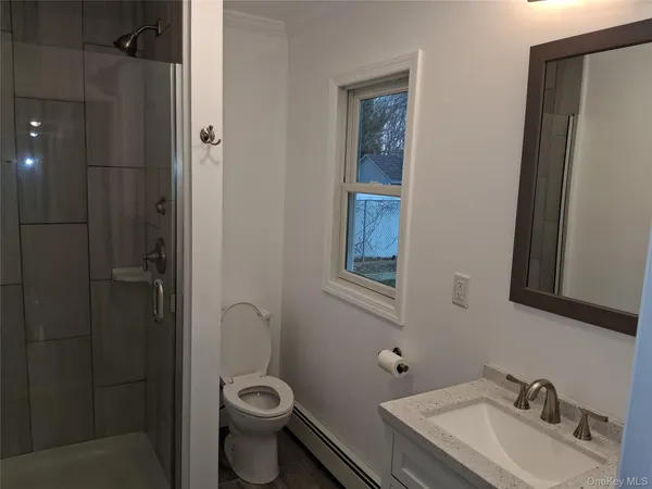 a bathroom with a toilet sink and shower
