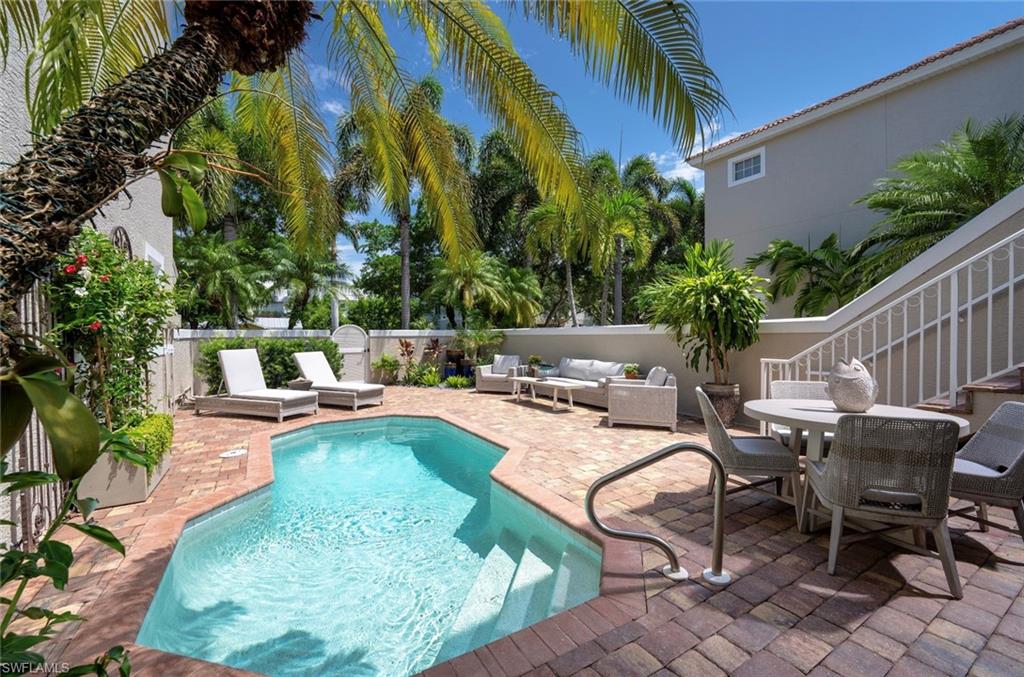 846 9th Avenue South, Unit 104 Naples, FL 34102 - Photo 1 of 11 a view of a swimming pool with chairs
