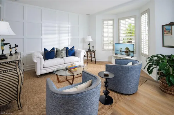 a living room with furniture and a large window