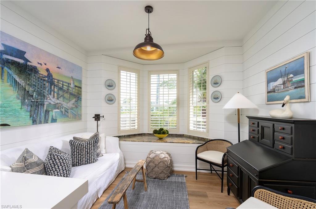 846 9th Avenue South, Unit 104 Naples, FL 34102 - Photo 5 of 11 a living room with furniture and a chandelier