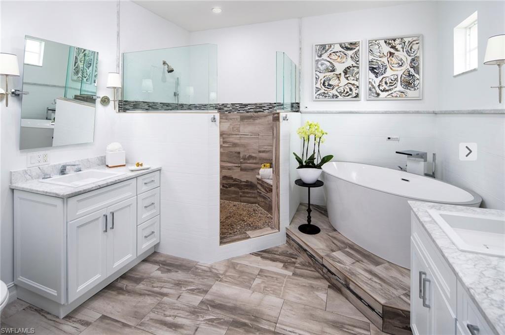 846 9th Avenue South, Unit 104 Naples, FL 34102 - Photo 8 of 11 a bathroom with a sink a toilet and shower