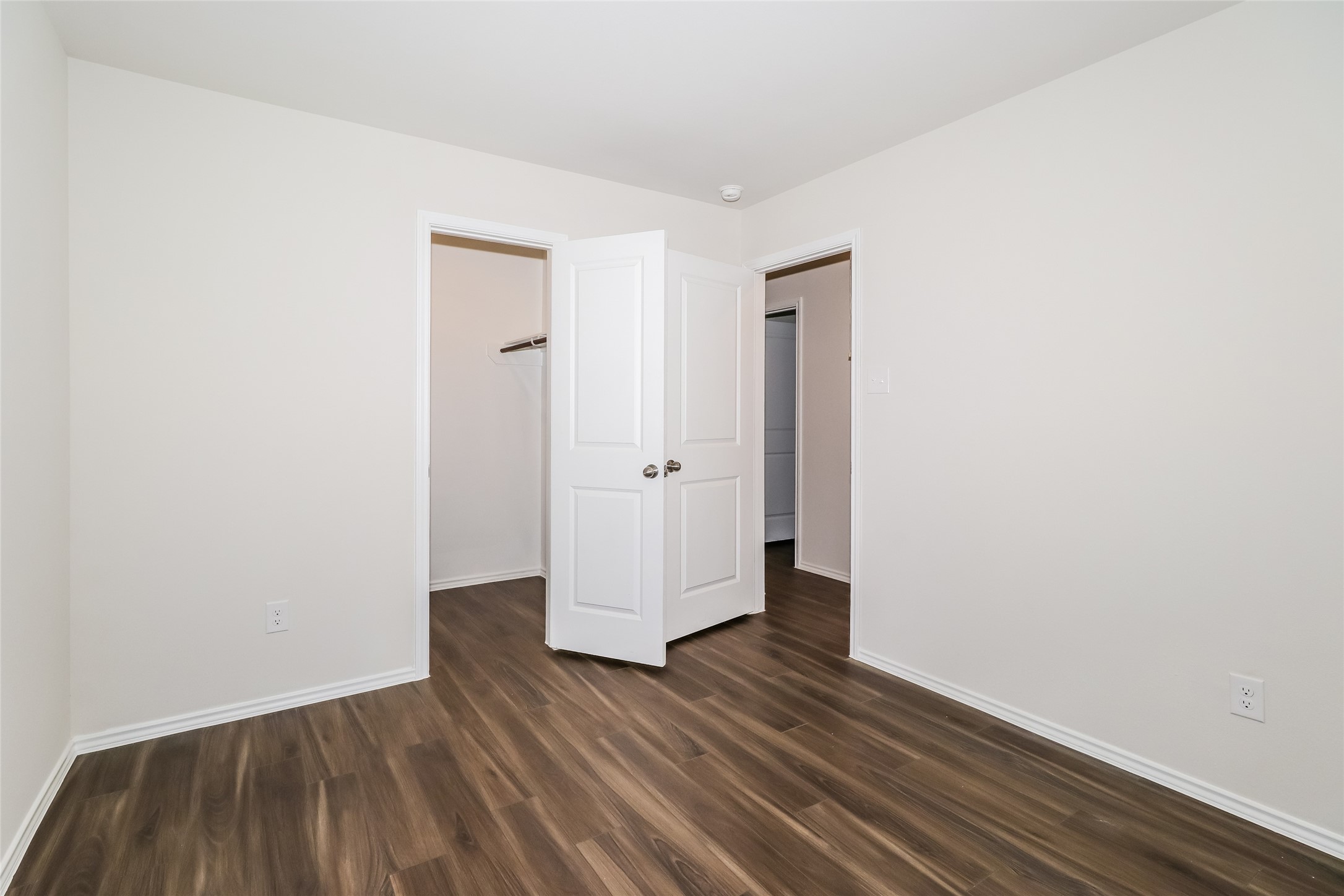 2146 Middle Rdg Drive Conroe, TX 77301 - Photo 11 of 21 an empty room with wooden floor and wooden door