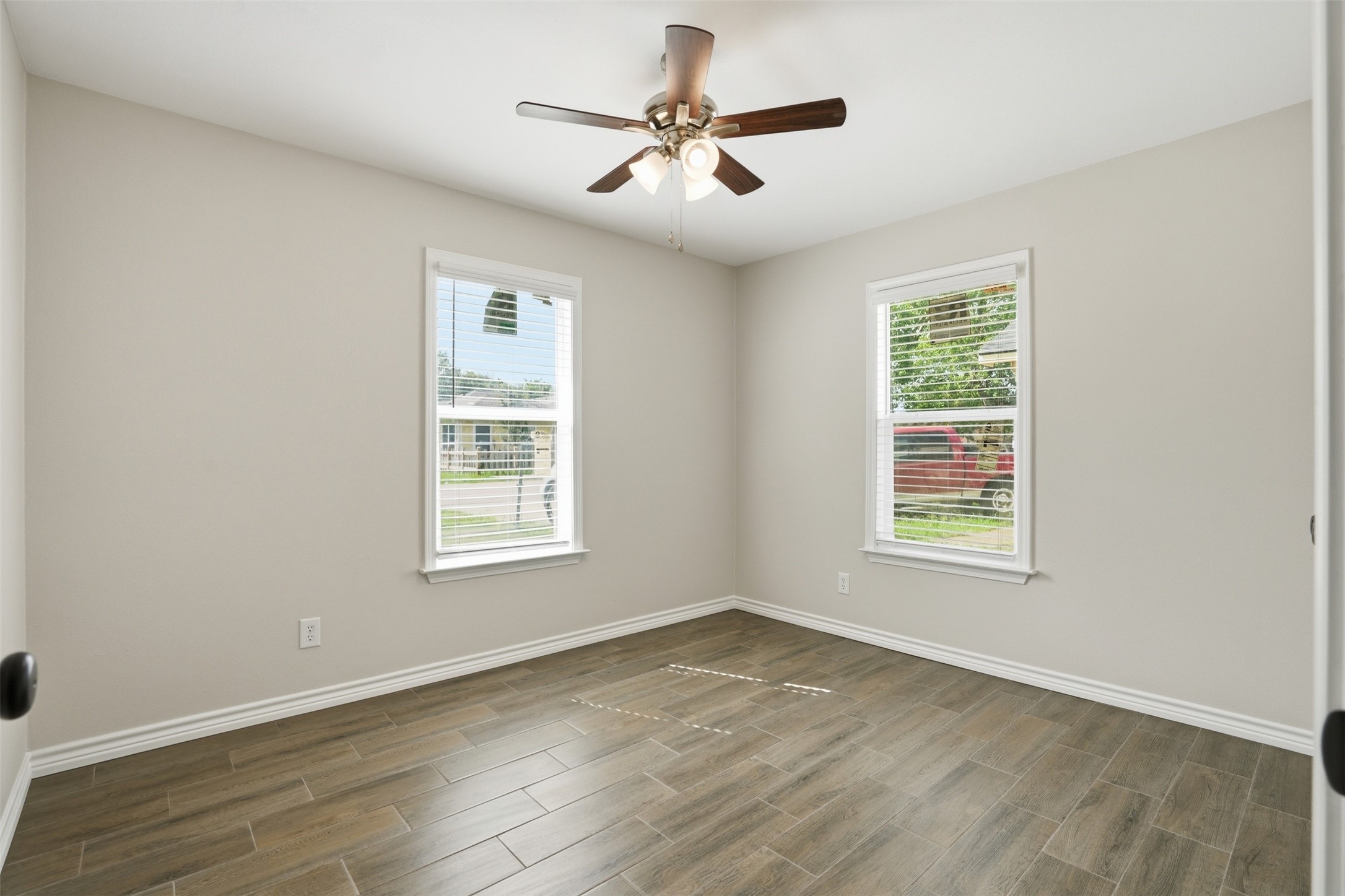 6518 Paris Street Houston, TX 77021 - Photo 5 of 23 a view of an empty room with wooden floor and a window
