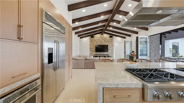a kitchen with stainless steel appliances granite countertop a stove and a refrigerator