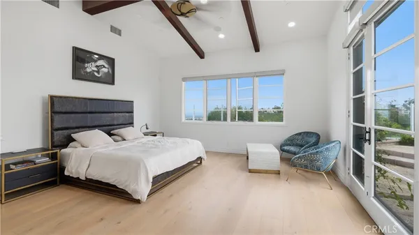 a bedroom with a bed and a chair