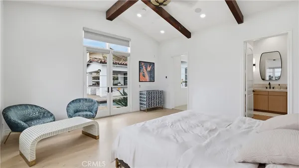a bedroom with furniture and a large mirror