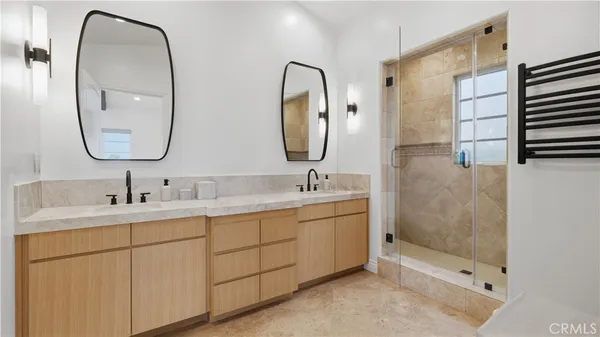 a bathroom with a double vanity sink and a mirror