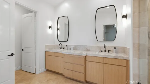 a bathroom with a double vanity sink and a mirror