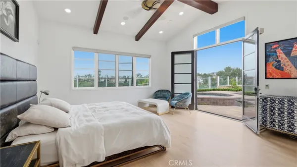 a bedroom with a bed couch and window