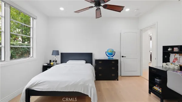 a bedroom with a bed and a window