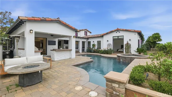 a view of a house with pool and chairs