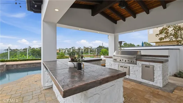 a view of a patio with a table and chairs