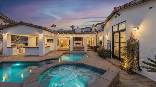 a view of a house with swimming pool and a yard