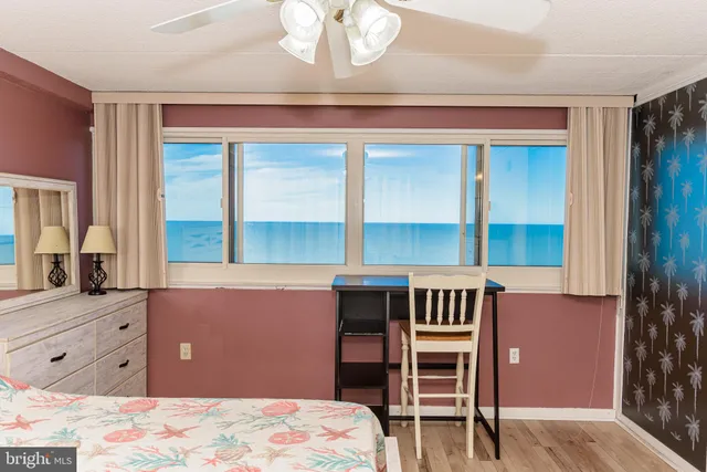 a bedroom with a bed and a dresser with mirror