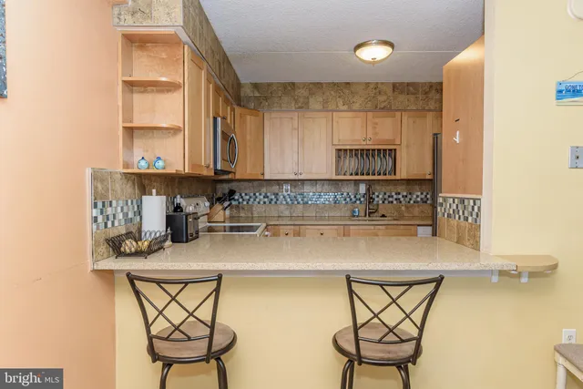 a kitchen with white cabinets a sink and white appliances