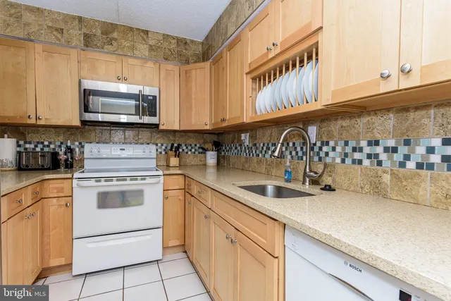 a bedroom with a bed and a flat tv screen on a dresser