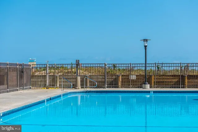 a view of a balcony with floor to ceiling windows