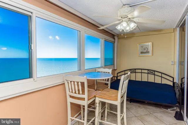 a view of a dining room with furniture and a window