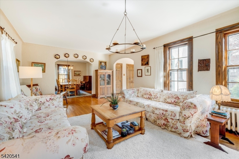 55 Luddington Road West Orange, NJ 07052 - Photo 11 of 40 a living room with furniture fireplace and a chandelier