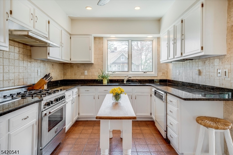 55 Luddington Road West Orange, NJ 07052 - Photo 19 of 40 a kitchen with stainless steel appliances granite countertop a stove a sink and white cabinets