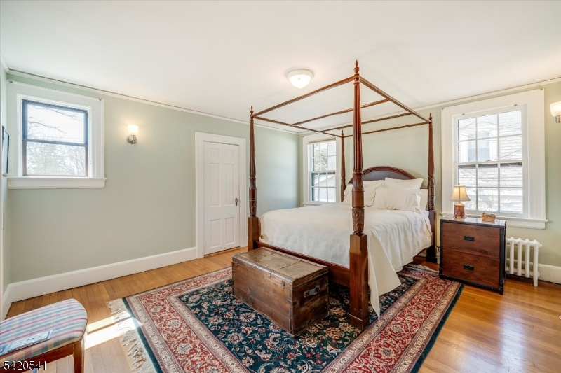 55 Luddington Road West Orange, NJ 07052 - Photo 28 of 40 a bedroom with a bed rug and wooden floor