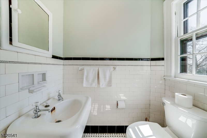 55 Luddington Road West Orange, NJ 07052 - Photo 29 of 40 a bathroom with a sink a toilet and shower