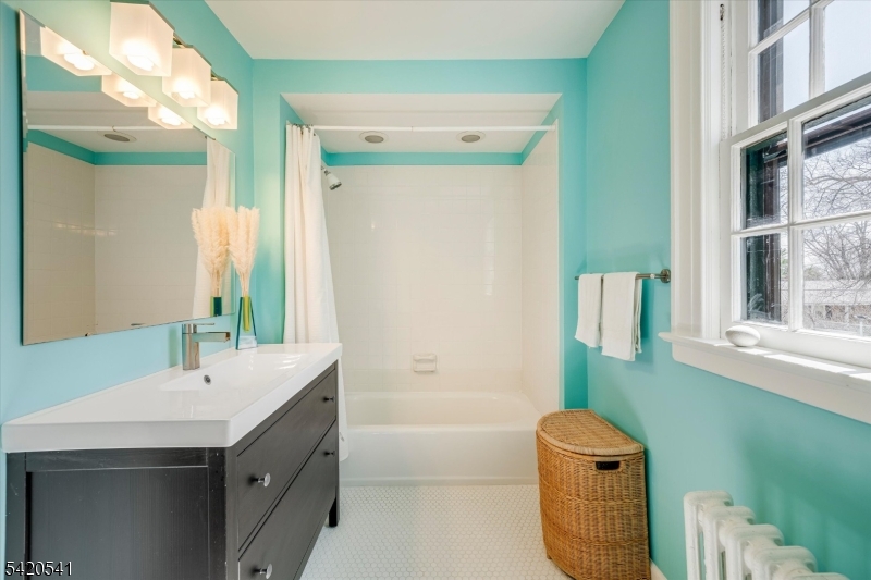 55 Luddington Road West Orange, NJ 07052 - Photo 32 of 40 a bathroom with a sink mirror toilet and bathtub