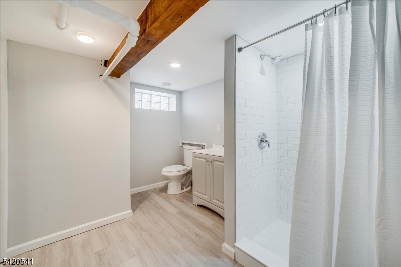 55 Luddington Road West Orange, NJ 07052 - Photo 34 of 40 a bathroom with a toilet a sink and shower