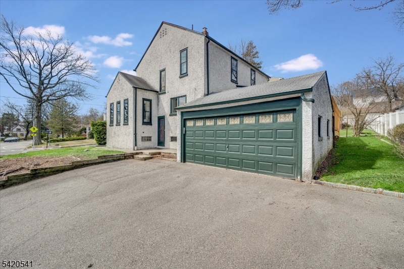 55 Luddington Road West Orange, NJ 07052 - Photo 36 of 40 a view of a house with a yard and garage