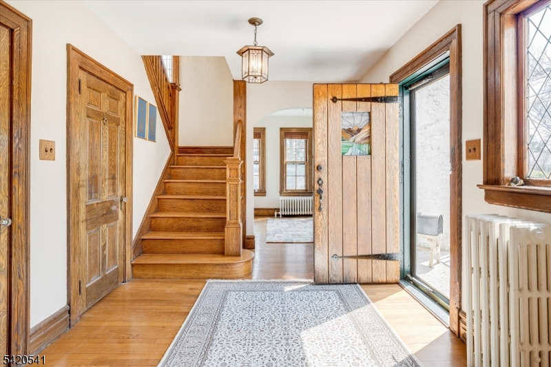 55 Luddington Road West Orange, NJ 07052 - Photo 5 of 40 a view of a hallway with wooden floor and staircase