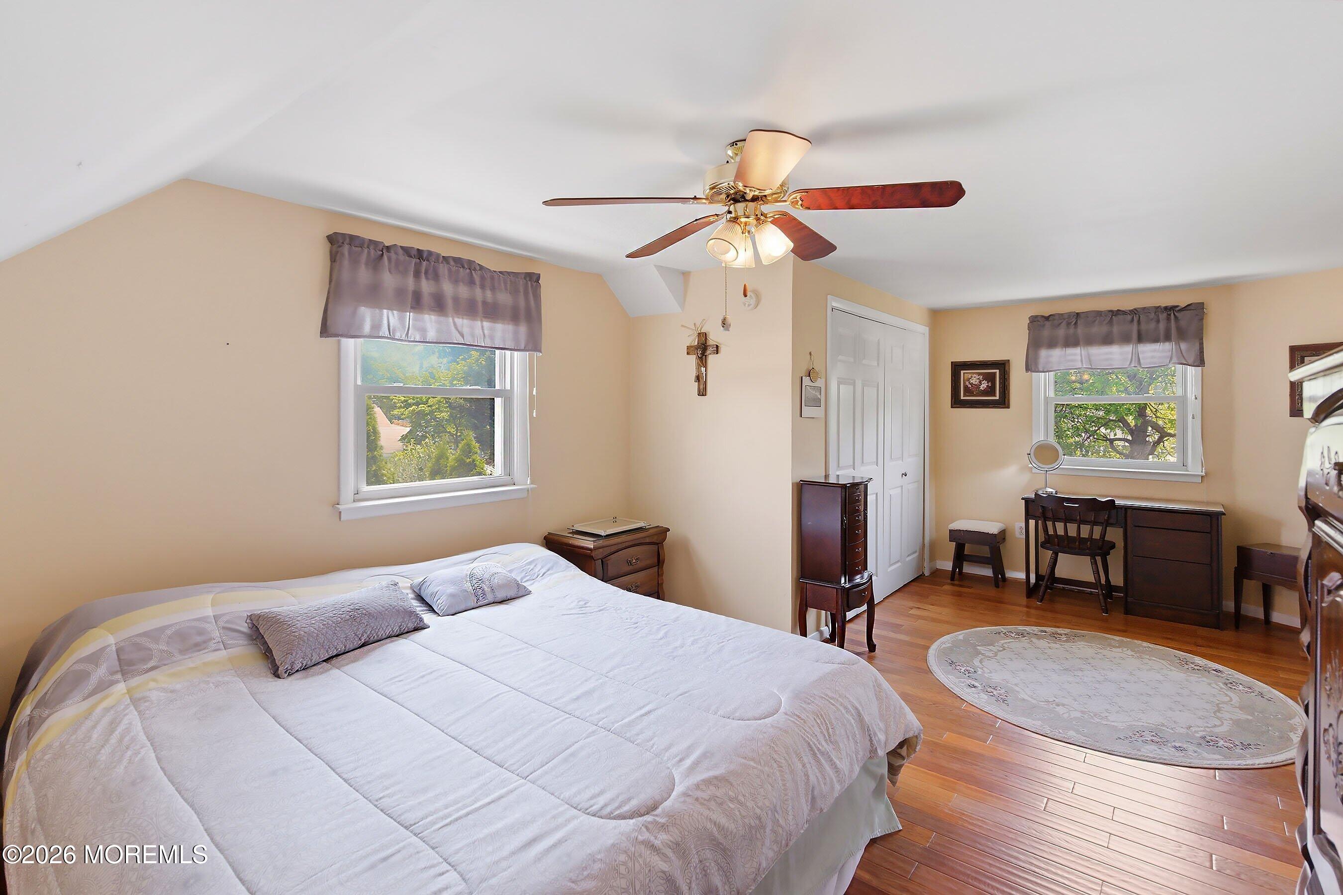 412 Moore Road Neptune Township, NJ 07753 - Photo 18 of 36 a bedroom with a bed and a chandelier